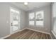 Airy sunroom with wood floors, natural light from many windows, and a door for easy outdoor access at 1468 Lexington Trl, Greenfield, IN 46140