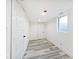 Finished basement space with white walls, wood-style flooring and natural light at 1511 E Tabor St, Indianapolis, IN 46203