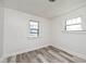 An empty bedroom with neutral tones, wood floors and two windows at 1511 E Tabor St, Indianapolis, IN 46203