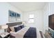 Cozy bedroom features neutral decor, plush bedding, and ample natural light from the window at 1511 E Tabor St, Indianapolis, IN 46203