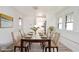 Staged dining room with bright natural light, wood floors, and decoratively set table at 1511 E Tabor St, Indianapolis, IN 46203