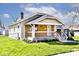 Charming single-story home featuring a wood porch, new landscaping, and beautiful curb appeal at 1511 E Tabor St, Indianapolis, IN 46203