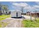 View of a detached single-car garage situated on a concrete pad with a fenced in yard at 1511 E Tabor St, Indianapolis, IN 46203