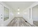Bright living room featuring new laminate flooring, a window, and white walls at 1511 E Tabor St, Indianapolis, IN 46203