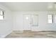 Bright living room featuring new laminate flooring, a window, and white walls at 1511 E Tabor St, Indianapolis, IN 46203