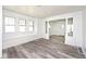 Bright living room featuring wood-look flooring, large windows and a built-in bench at 1511 E Tabor St, Indianapolis, IN 46203