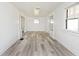 Bright living room featuring new laminate flooring, a window, and white walls at 1511 E Tabor St, Indianapolis, IN 46203