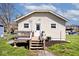 A cozy single-story home features a wooden deck, and a well-maintained lawn at 1511 E Tabor St, Indianapolis, IN 46203