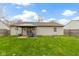 View of the backyard showcasing the lush green grass, outdoor patio, and fire pit for enjoying outdoor living at 1517 Citation N Cir, Lebanon, IN 46052