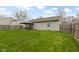A spacious backyard features a well-maintained lawn, fire pit, and covered outdoor seating area, perfect for relaxing and entertaining at 1517 Citation N Cir, Lebanon, IN 46052