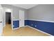 Bedroom with hardwood floors, half blue wall, door to another room and closet at 1517 Citation N Cir, Lebanon, IN 46052
