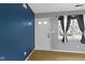 Clean entryway featuring neutral walls, a bright white door, and natural light from the side window at 1517 Citation N Cir, Lebanon, IN 46052