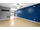 Bright living room with hardwood floors, gray walls, and dark blue accent wall, seamlessly flowing into the dining area at 1517 Citation N Cir, Lebanon, IN 46052