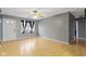Bright living room with neutral gray walls and gleaming hardwood floors, illuminated by natural light at 1517 Citation N Cir, Lebanon, IN 46052