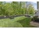 A well-manicured lawn and mulched flower beds define the backyard at 16422 Brigham Ln, Westfield, IN 46074