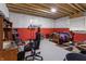 Unfinished basement space with a dedicated gaming area and space for storage at 16422 Brigham Ln, Westfield, IN 46074