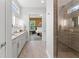Bathroom with double vanity, granite countertops, tile floors, and glass enclosed shower at 16422 Brigham Ln, Westfield, IN 46074