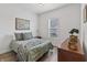 Comfortable bedroom with light wood floors and large window offering natural light at 16422 Brigham Ln, Westfield, IN 46074