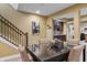 Basement dining area with a modern table, chairs, and staircase access at 16422 Brigham Ln, Westfield, IN 46074