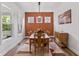 Elegant dining room featuring a wood table, stylish light fixture, and rustic accent wall at 16422 Brigham Ln, Westfield, IN 46074