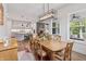 Bright dining room area offering a wooden table with seating and access to the screened porch at 16422 Brigham Ln, Westfield, IN 46074