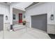 Inviting front porch featuring a red door, gray two-car garage, and stylish exterior lighting at 16422 Brigham Ln, Westfield, IN 46074
