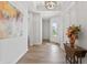 Bright hallway features wood flooring, elegant light fixture, and a view of the front door at 16422 Brigham Ln, Westfield, IN 46074