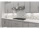 Modern kitchen with stainless steel range hood, gas cooktop and lovely tile backsplash at 16422 Brigham Ln, Westfield, IN 46074