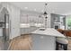 Open kitchen boasts an island with counter seating, white cabinets, and modern appliances at 16422 Brigham Ln, Westfield, IN 46074