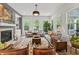 Sun-filled living room with fireplace, large windows, stylish furniture and hardwood floors at 16422 Brigham Ln, Westfield, IN 46074