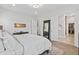 Bright main bedroom with walk-in closet, light wood floors, and ensuite bathroom at 16422 Brigham Ln, Westfield, IN 46074