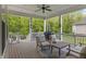 Inviting covered porch with ample seating and views of the wooded surroundings at 16422 Brigham Ln, Westfield, IN 46074