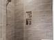 Close up view of the tiled shower with a shower niche for storage at 16422 Brigham Ln, Westfield, IN 46074