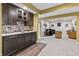 Stylish basement wet bar with dark cabinetry and modern backsplash at 16422 Brigham Ln, Westfield, IN 46074