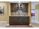 Elegant wet bar with dark wood cabinets and quartz countertops in the basement at 16422 Brigham Ln, Westfield, IN 46074