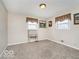 Spare bedroom featuring neutral decor, carpet, and two windows with patterned valances at 1734 Bittersweet Dr, Anderson, IN 46011