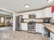 Bright kitchen featuring white cabinets, stainless steel appliances, and convenient access to the home's living areas at 1734 Bittersweet Dr, Anderson, IN 46011