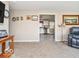 Open living room leading to a bright kitchen, featuring neutral walls and plush carpeting for a cozy feel at 1734 Bittersweet Dr, Anderson, IN 46011