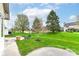 Expansive backyard featuring a lush lawn, mature trees, and a charming patio area, perfect for outdoor entertaining at 18009 Sun Ridge Cir, Noblesville, IN 46062