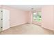 Cozy bedroom with soft pink walls, plush carpet, and a large window offering plenty of sunlight at 18009 Sun Ridge Cir, Noblesville, IN 46062