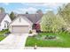 Charming single-story home featuring manicured lawn, brick facade, and attached two-car garage at 18009 Sun Ridge Cir, Noblesville, IN 46062