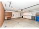 Spacious garage with overhead lighting, utility sink, storage cabinets, and a work bench at 18009 Sun Ridge Cir, Noblesville, IN 46062