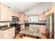 Kitchen with granite countertops, central island and stainless steel appliances at 18009 Sun Ridge Cir, Noblesville, IN 46062