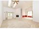 Spacious living room featuring carpet, fireplace, ceiling fan and skylights offering natural light at 18009 Sun Ridge Cir, Noblesville, IN 46062