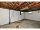 Unfinished basement offering a blank canvas with exposed beams, ready for customization and extra storage at 1934 N Arlington Ave, Indianapolis, IN 46218