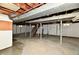 Unfinished basement with exposed ductwork, wooden beams, and a concrete floor, ready for your creative vision at 1934 N Arlington Ave, Indianapolis, IN 46218