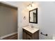 Modern half bath with quartz counters and wood-look vanity at 1934 N Arlington Ave, Indianapolis, IN 46218