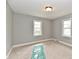 Bright bedroom with neutral carpet, grey walls, white trim, and two windows providing natural light at 1934 N Arlington Ave, Indianapolis, IN 46218