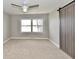 Spacious bedroom featuring a ceiling fan, large window, and closet with modern sliding door at 1934 N Arlington Ave, Indianapolis, IN 46218