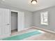 Bedroom with neutral carpet, closet with sliding door, white trim, grey walls, and ample natural light at 1934 N Arlington Ave, Indianapolis, IN 46218